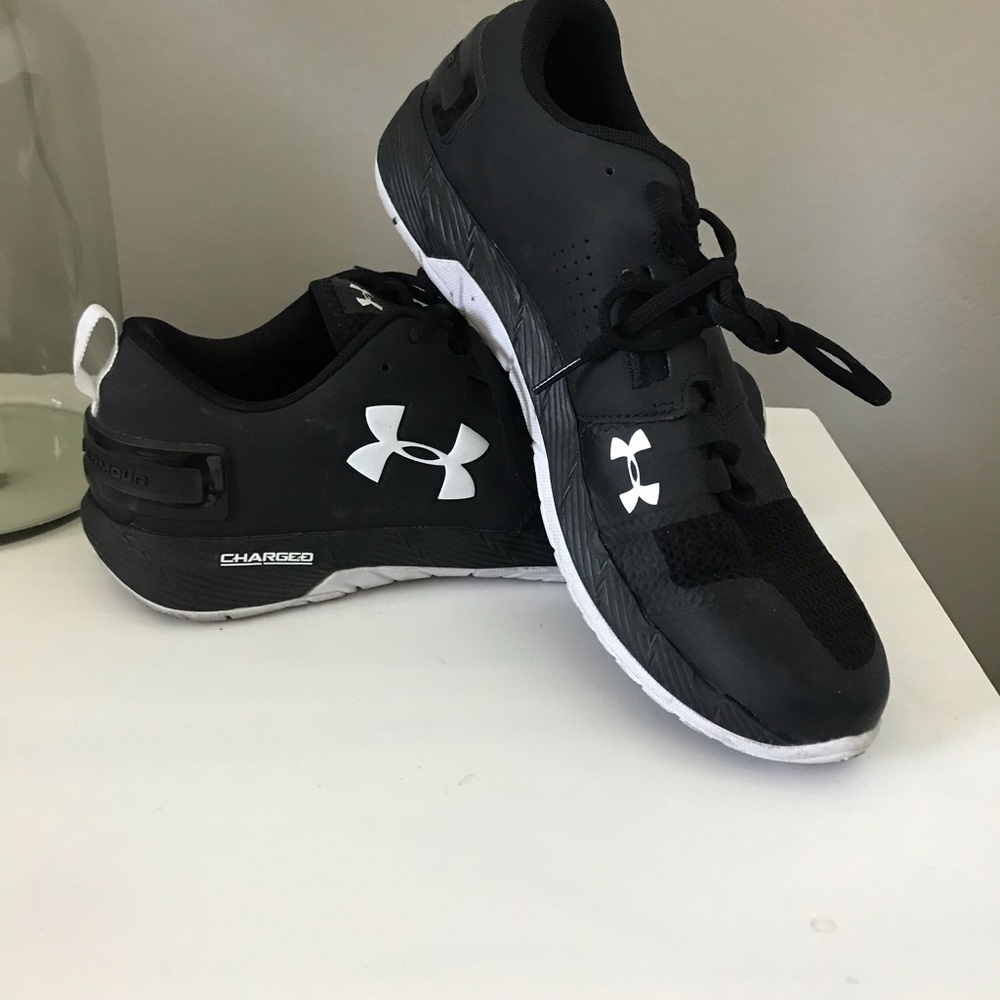 Black and white Under Armour running shoes